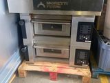 a stack of ovens sitting on a pallet in a garage