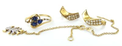 trois bagues et un collier posés sur une surface blanche