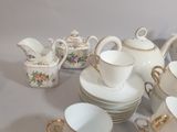 a lot of cups and saucers that are sitting on a table