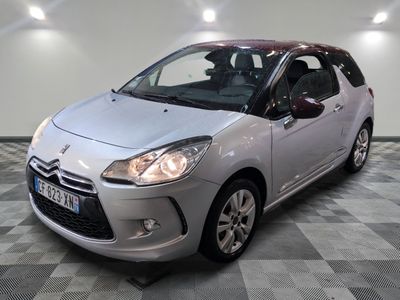 la petite voiture argentée est garée sur un carrelage à carreaux