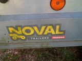 the back end of a trailer with a noval trailer sticker on it