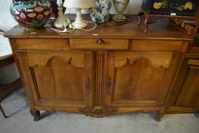 a wooden cabinet with a lamp on top of it