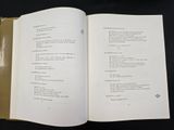 a book open on a black table with a black background