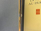 un livre ouvert posé sur une table recouverte d'un tissu bleu