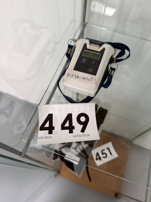 a display case with a cell phone and a price tag on it
