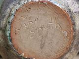 a close up of a vase with writing on it