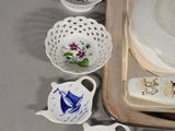 a tray with cups and saucers on it and a tray with dishes on it