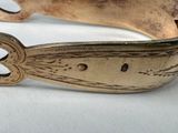 a silver bracelet that has a design on it