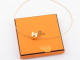 an orange box with a gold cross on it and a gold chain