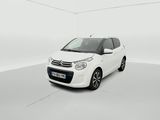 a small white car is parked in a white room