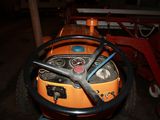 an orange tractor with a steering wheel and a steering wheel