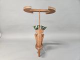 a wooden table with a planter on top of it