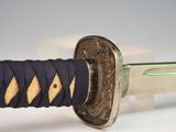 a close up of a sword with a blue handle