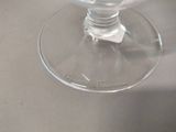 a glass of wine sitting on a counter top