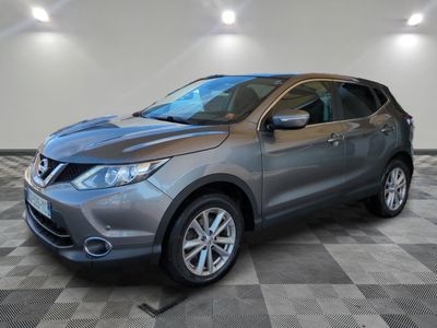 a gray nissan suv parked in a garage with a checkered floor