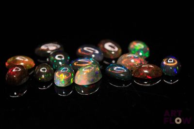 a close up of a group of oplite stones on a black surface