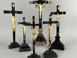 three black and gold crucifs with jesus on the cross