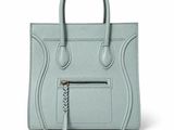 a light blue handbag with a zipper on the front