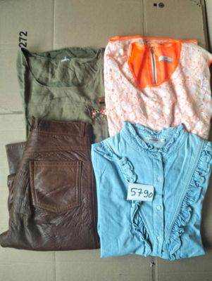 a lot of clothes that are sitting on the floor