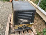 a black and yellow machine sitting on top of a wooden pallet