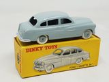two toy cars sitting on top of a box on a white surface