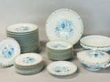 a lot of plates and bowls that are sitting on a table