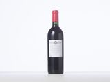the bottle of red wine is sitting on the table
