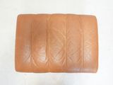 an image of a brown leather seat cushion on a white surface