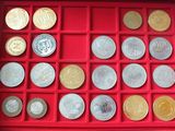 a red box with many different coins in it
