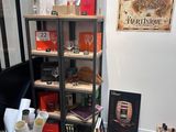 a room with a book shelf and various items on it