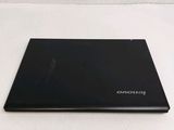 laptop on a white table with a white background and a logo on the screen