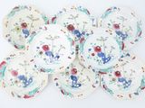six plates with floral designs are arranged on a white surface