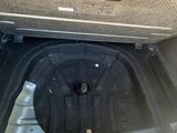 the trunk of a car with a black object in the trunk