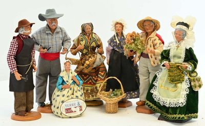 many figurines of people dressed in traditional clothing