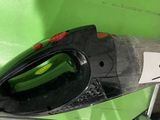 a green and black steam iron sitting on top of a green wall
