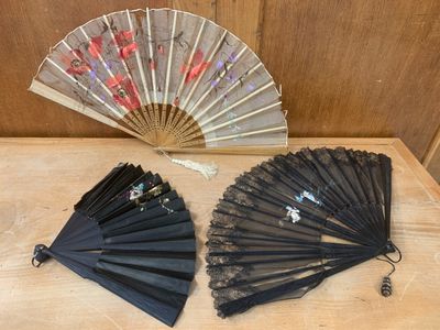 two black fans sitting on a table next to each other