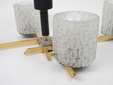 three candles that are sitting on a wooden stand