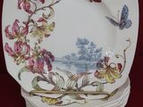 a stack of plates with a butterfly and flowers on them
