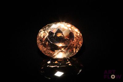 gros plan d'un diamant orange sur une surface noire