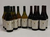 six bottles of wine are lined up in a row on a table