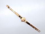 a close up of a wrist watch on a white surface