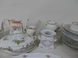 many plates and cups and saucers on the table