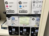 many boxes of ink sitting on a shelf next to a printer