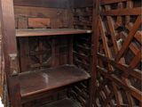 a wooden cabinet that has a shelf in it