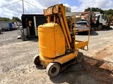 a small yellow machine that is parked in the dirt