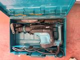 a blue tool in a blue box on the floor