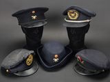 several hats are lined up in a row on a black surface