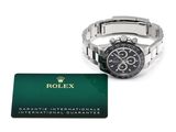 a close up of a watch and a credit card on a white surface