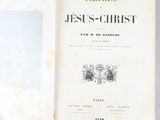 a book with a picture of jesus on it sitting on a table