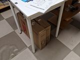 a white table with a laptop on it in a room